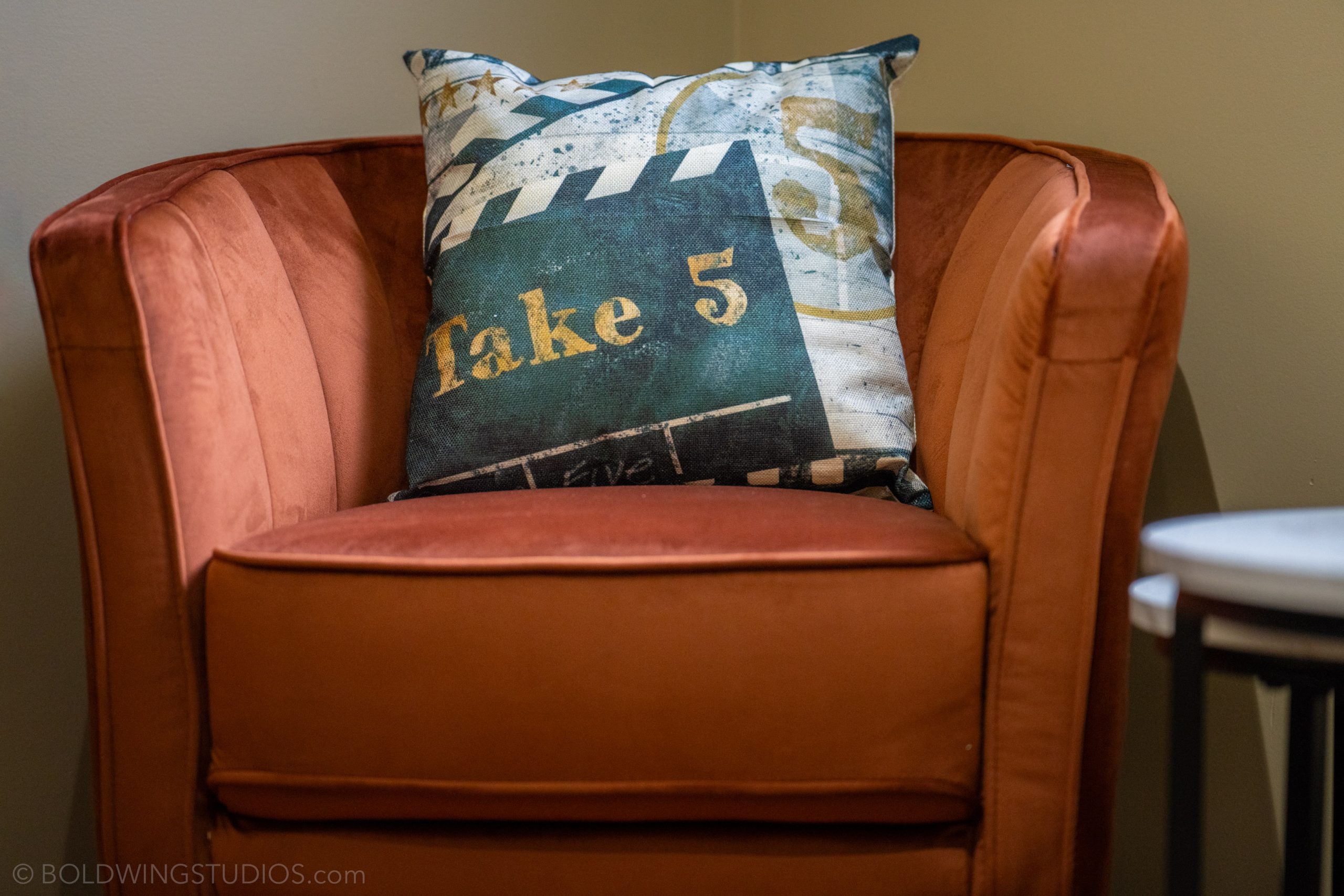 An orange armchair with a Take 5 cushion