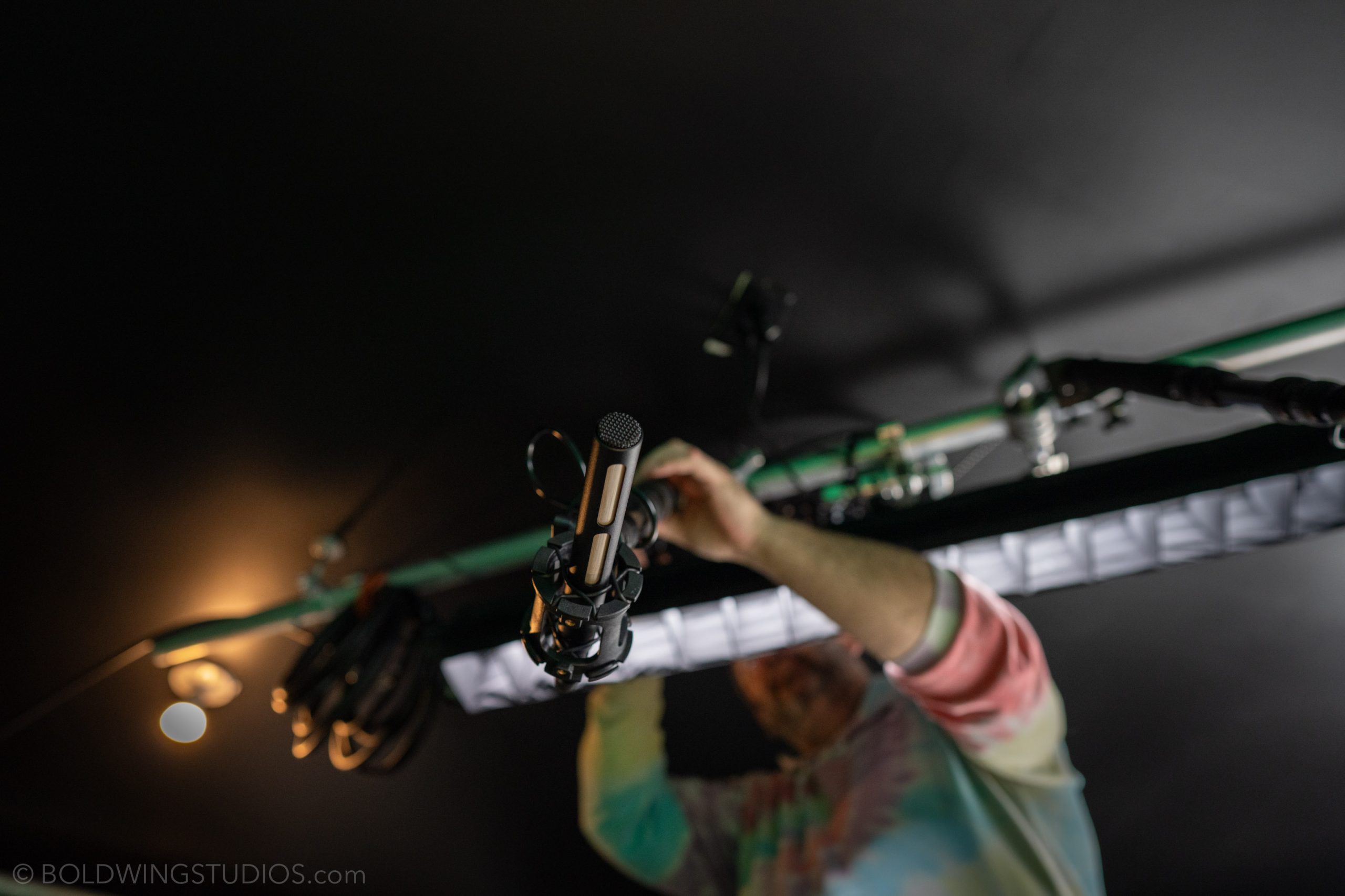 A crew member adjusting the lighting rig